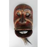 A POLYCHROME CARVED WOODEN DANCE MASK (TOPENG) of Kebo Sepati Bali or Lombok, Indonesia, finely