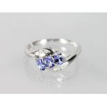 A 9CT WHITE GOLD, TANZANITE AND DIAMOND RING.