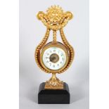 A SMALL GILDED LYRE CLOCK, on a marble base. 8.5ins high.