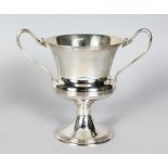 A TWO-HANDLED CHALICE CUP with reeded bands. 7.5ins high. Sheffield 1937. Makers: James Deakin &