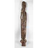 A LARGE EARLY CARVED WOOD SLENDER FIGURE OF A SAINT. 44ins high.