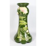 A JULIUS DRESSLER POTTERY JARDINIERE STAND, green glazed with moulded floral decoration. 2ft high.