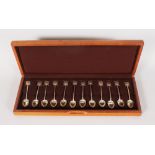 A SET OF TWELVE SHANGHAI SCOTTISH SILVER SPOONS in an oak case.