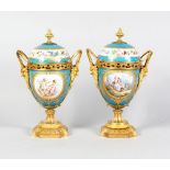 A SUPERB PAIR OF 19TH CENTURY SEVRES PORCELAIN AND GILDED ORMOLU TWO-HANDLED URN SHAPED VASES AND