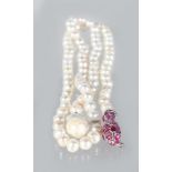 A BAROQUE PEARL NECKLACE with ruby set snake clasp.