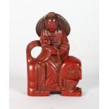 A LACQUER CHINESE FIGURE RIDING AN ELEPHANT. 3ins high.