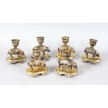A SUPERB SET OF SIX SILVER GILT "PIG" CANDLESTICKS formed as a standing pig with a series of holes