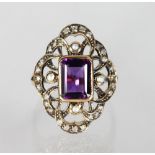 A 9CT GOLD EMERALD CUT AMETHYST, PEARL AND DIAMOND RING.