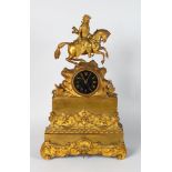 A 19TH CENTURYFRENCH GILT MANTLE CLOCK with enamel dial, eight day movement, surmounted by a man