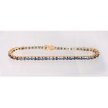 A 14K YELLOW GOLD AND SAPPHIRE LINE BRACELET.