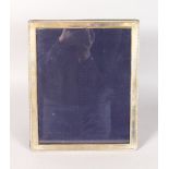 AN UPRIGHT PHOTOGRAPH FRAME with bead edge. 11ins high x 9ins wide.