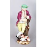 A SMALL 19TH CENTURY MEISSEN BOY PLAYING A PIPE, a dog by his side. Cross swords mark in blue.