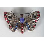 A LARGE BUTTERFLY BROOCH, set with cabochon rubies and sapphires. 3ins wide.