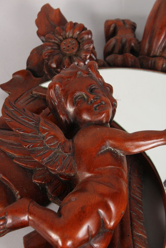 A GOOD CARVED WOOD CHERUB MIRROR with crescent shaped mirror. 23ins long. - Image 2 of 2