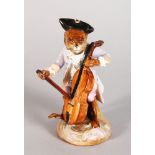 A CONTINENTAL PORCELAIN MONKEY FIGURE PLAYING A CELLO. 5in high.