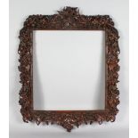 A WELL CARVED WALNUT FOLIAGE PICTURE FRAME. 28ins long x 23ins wide.
