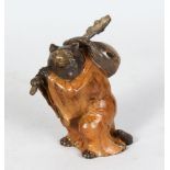 A SMALL COLD PAINTED BRONZE OF A BEAR, carrying a stick and bag on his shoulder. 4ins high.