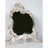 A VERY GOOD SILVERED BRONZE SHAPED EASEL MIRROR with bevelled edge. 25ins high.