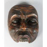 A POLYCHROME CARVED WOODEN DANCE MASK (TOPENG) of Kebo Sepati Bali or Lombok, Indonesia, finely