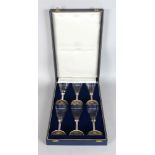 THEO FENNELL, A SET OF SIX CHAMPAGNE GLASSES, with silver cluster column stems on a broad foot,