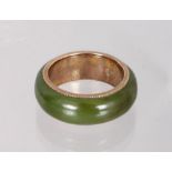 AN 18CT YELLOW GOLD AND JADE WEDDING BAND.