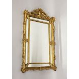 A CARVED GILTWOOD PIER MIRROR. 3ft 0ins high x 1ft 10ins wide.