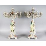 A LARGE PAIR OF MEISSEN DESIGN SEVEN LIGHT ENCRUSTED CANDELABRA, the stems with classical young