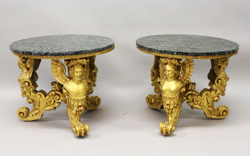 A GOOD PAIR OF 20TH CENTURY CARVED AND GILDED CIRCULAR LOW TABLES, with marble tops, the bases