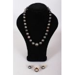 A FINE SUITE OF SOUTH SEA GRADUATED PEARLS to include ring diamond set, with necklace and earrings.