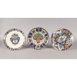 THREE POLYCHROME DUTCH DELFT PLATES, MID-LATE 18TH CENTURY, boldly painted in blues, iron-reds,