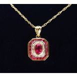 A 9CT GOLD, RUBY AND DIAMOND ART DECO DESIGN PENDANT AND CHAIN.