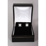 A PAIR OF 18CT WHITE GOLD PRINCESS CUT DIAMOND STUD EARRINGS of 2.2CTS, Colour H, Clarity Si.