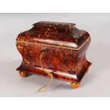 A VERY GOOD REGENCY TORTOISESHELL TWO DIVISION TEA CADDY, with mother-of-pearl handles, on satinwood