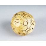 A RARE CARVED SCRIMSHAW IVORY ALPHABET GAME DICE with capital letters A-Z. 1.75ins diameter.