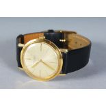 AN 18CT GOLD V. BUECHE GIROD WRISTWATCH with leather strap.