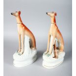 A LARGE PAIR OF STAFFORDSHIRE SEATED WHIPPETS on waisted gilt line bases, with dead rabbits