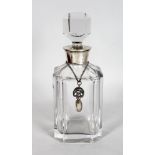 A SQUARE GLASS WHISKY DECANTER AND STOPPER with silver band.