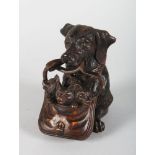 A CARVED WOOD BLACK FOREST DOG WITH PUPPIES INKWELL. 5ins high.