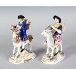A PAIR OF SAMSON "DERBY" FIGURES, COBBLER & HIS WIFE RIDING GOATS, Derby mark in gold. 6ins high.