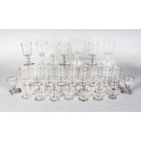 A QUANTITY OF TWENTY-FIVE WINE GLASSES, some plain and some engraved.