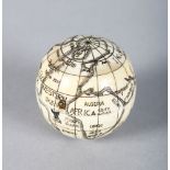 AN ETCHED BONE POCKET GLOBE COMPASS.