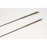 TWO SOLOMON ISLANDS BARBED SPEAR, the shaft undecorated, one with woven cane haft. 97ins and 93ins