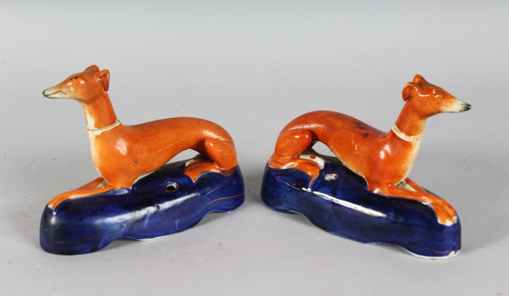 A PAIR OF STAFFORDSHIRE WHIPPET PEN HOLDERS on a blue base. 6ins long.