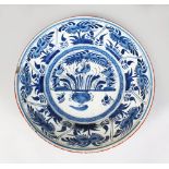 AN 18TH CENTURY DELFT BLUE AND WHITE TIN GLAZE CIRCULAR CHARGER, sunflowers and birds. 13.5ins