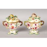 A PAIR OF COALBROOKDALE TWO HANDLED FLOWER ENCRUSTED POTS AND COVERS. 5ins high.