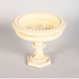 A EUROPEAN CARVED IVORY PEDESTAL URN. 3ins high.