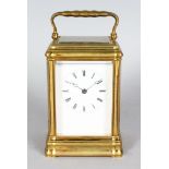 A 19TH CENTURY FRENCH BRASS CARRIAGE CLOCK with bell. 5.75ins high.