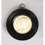 A GOOD EUROPEAN CARVED IVORY CIRCULAR PLAQUE, two classical Roman busts. 2,75ins diameter, in a