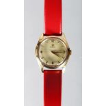 AN OMEGA 18K GOLD TURLER WRISTWATCH with red leather strap.