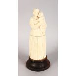 A 19TH CENTURY EUROPEAN CARVED IVORY MOTHER AND CHILD, the body opens to reveal a triptych, Christ